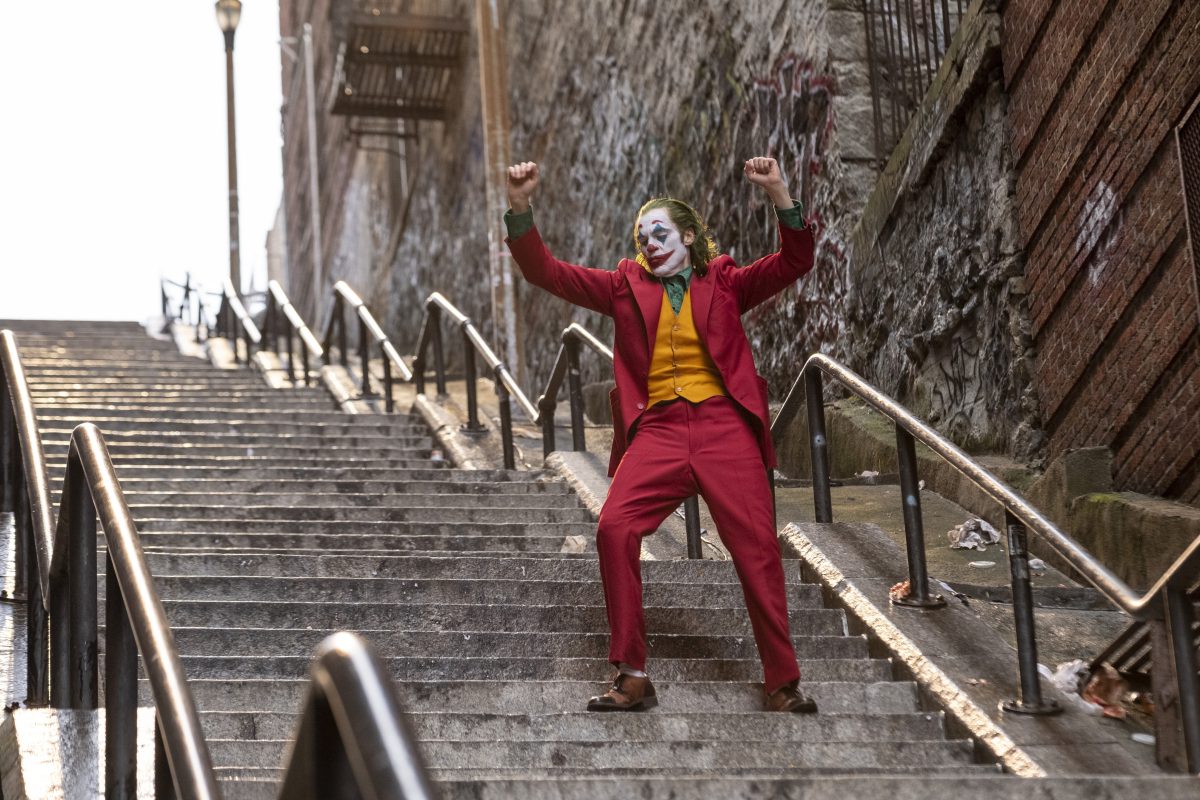 This image released by Warner Bros. Pictures shows Joaquin Phoenix in a scene from "Joker." A set of outdoor steps in the Bronx has become a tourist attraction in recent weeks since the release of the movie. The stairs are between two buildings on Shakespeare Avenue, about a half-mile from Yankee Stadium. (Niko Tavernise/Warner Bros. Pictures via AP)