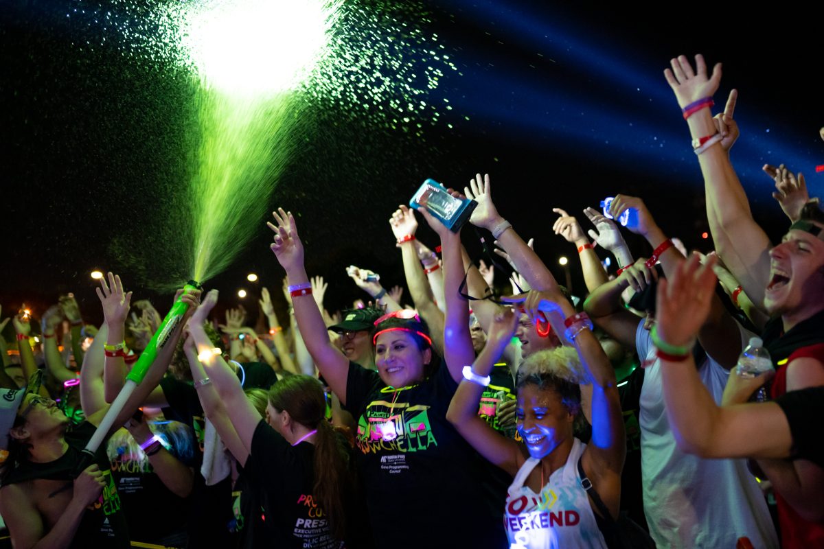 Students get covered in paint at Glowchella on Friday night. JENNIFER LINDAHL| THE ALL STATE