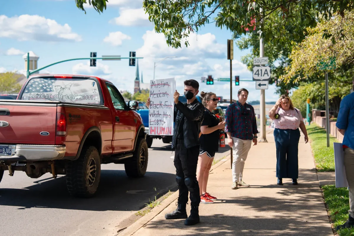 Seven Kubena holds a protest sign denouncing racism at Austin Peay State University, Sept 19, 2024. The demonstration highlights concerns over the university's hiring practices and alleged failure to vet a an employee linked to extremist groups.