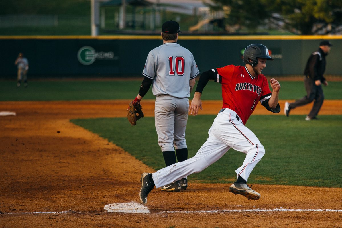 Kyle Wilson stretches to reach home against Southeast Missouri. BENJAMIN LITTLE | THE ALL STATE