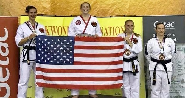 Honeycutt stands in the gold medal spot at center with teammates Jenna Davis, left, and Alexis Medlin, second from right. A competitor from Great Britain, C. Quinn, also won bronze.