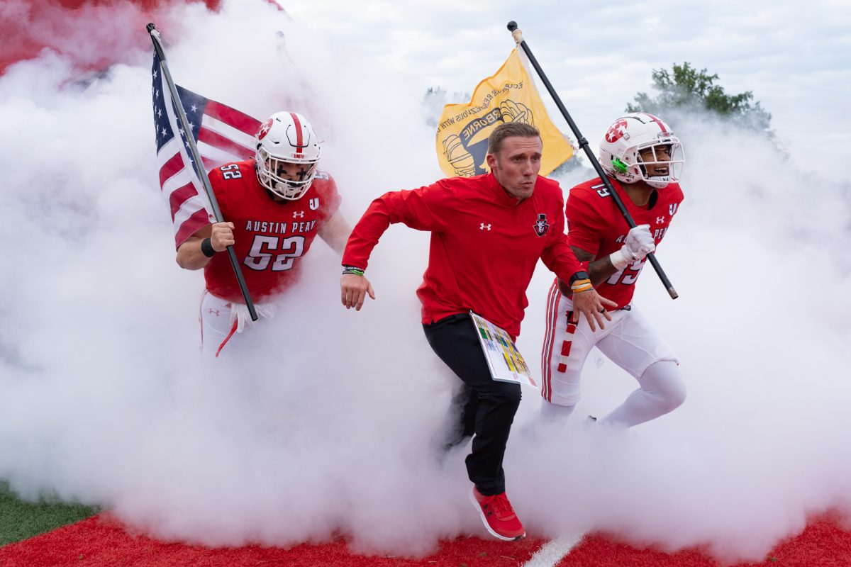 Head coach Scotty Walden leads his team to the field during Saturday's home-opener game. JENNIFER LINDAHL| THE ALL STATE