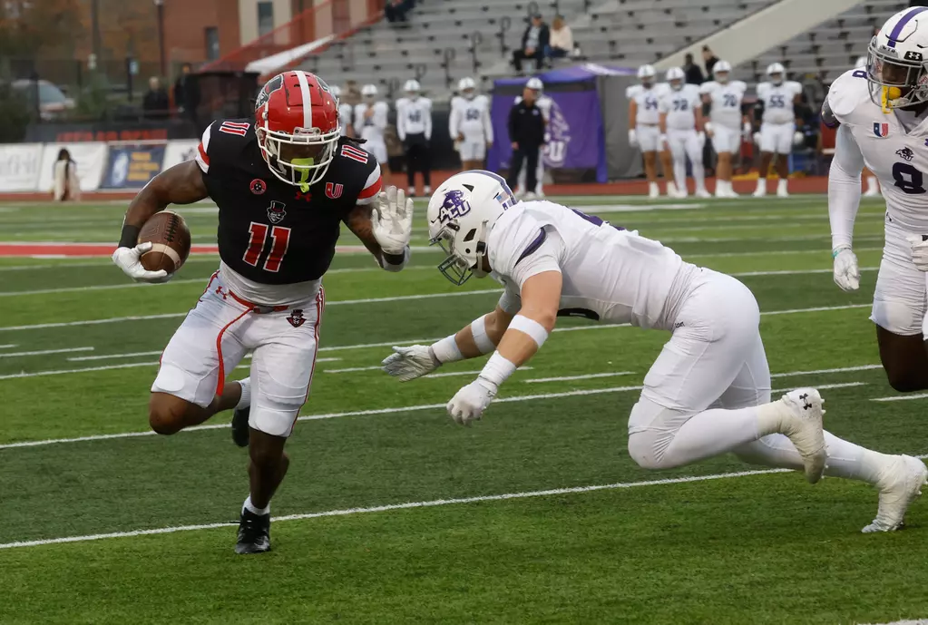 Austin Peay State University running back La'Vell Wright looks to get past this Abilene Christian defender Saturday at Fortera Stadium in Clarksville.