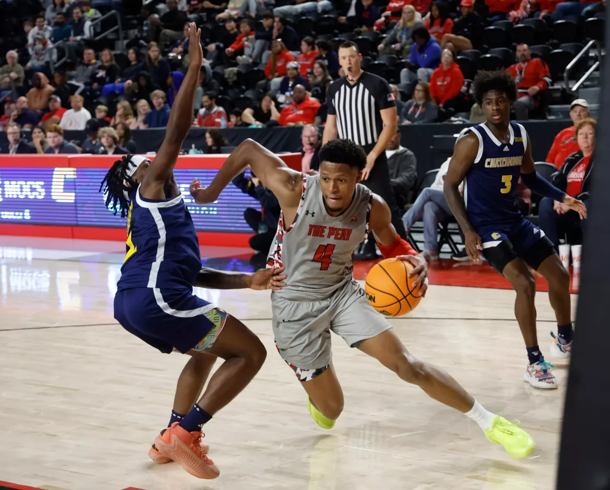 Austin Peay State University guard LJ Thomas getting past University of Tennessee at Chattanooga defender. 