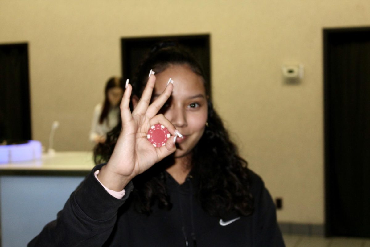 Julia Munoz held up her winning Black Jack chip at APSU's Clarksvegas event at 416 College St. on Jan. 23. 