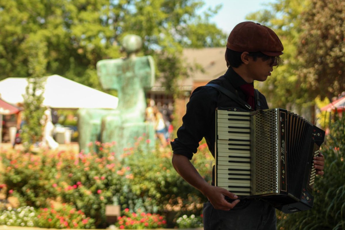 J.S. Bertoni, a student at Austin Peay who bought a cheap accordion after wanting one for a while, plays for passing students as they walk to class on Aug. 26, 2025.