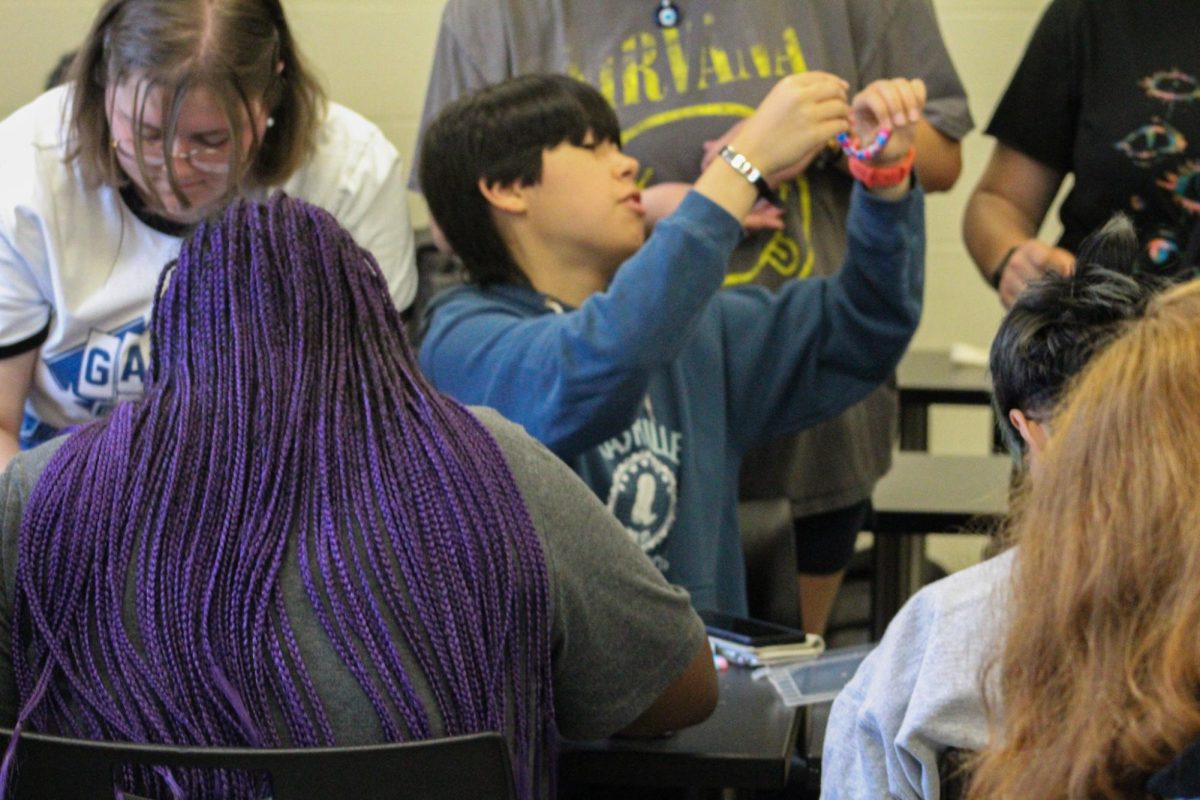 Students connect over colorful beads and Pride at SAGA’s bracelet-making workshop.