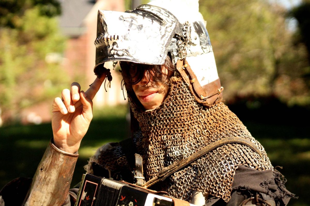 "Bertoni", an APSU student, tilts open his helmet for the camera in front of the library. 