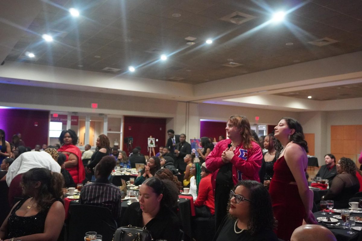Students stand to applaud an award recipient at the Wilbur N. Daniel African American Cultural Center's Night of Melanin Magic Award Ceremony in the MUC Ballroom on Friday, Feb. 20th 2026. 