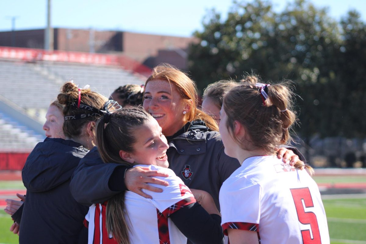 Sophia Schwab and Jillian Corl celebrate with Brooke Landry during Austin Peay's 15-14 win against Gardner-Webb on Saturday, Feb. 7, 2026.