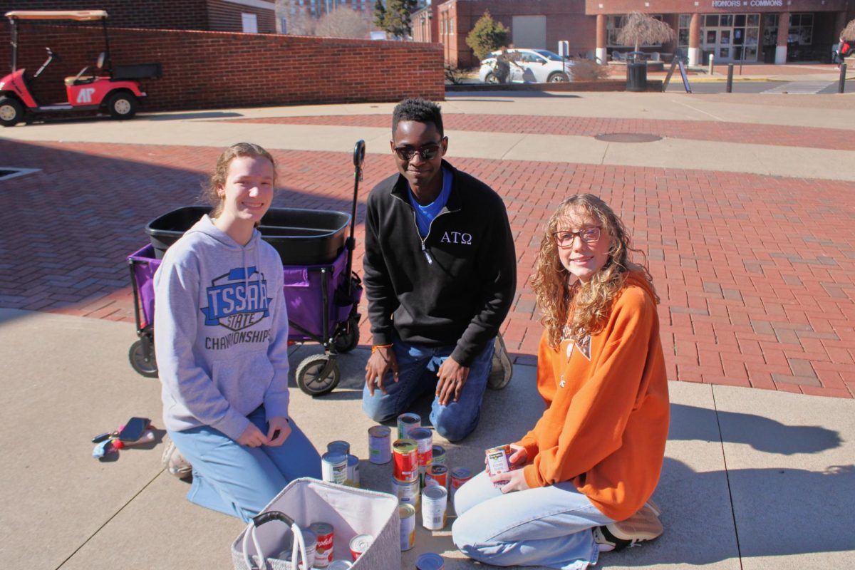Delta Pi starting their tower during the Tower of Cans event on Friday, Feb. 13.