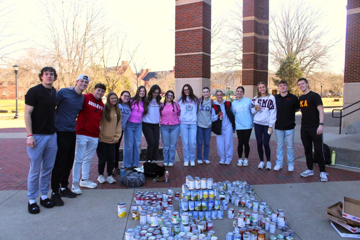 Kappa Alpha and Chi Omega starting their tower during the Tower of Cans event on Friday, Feb. 13.