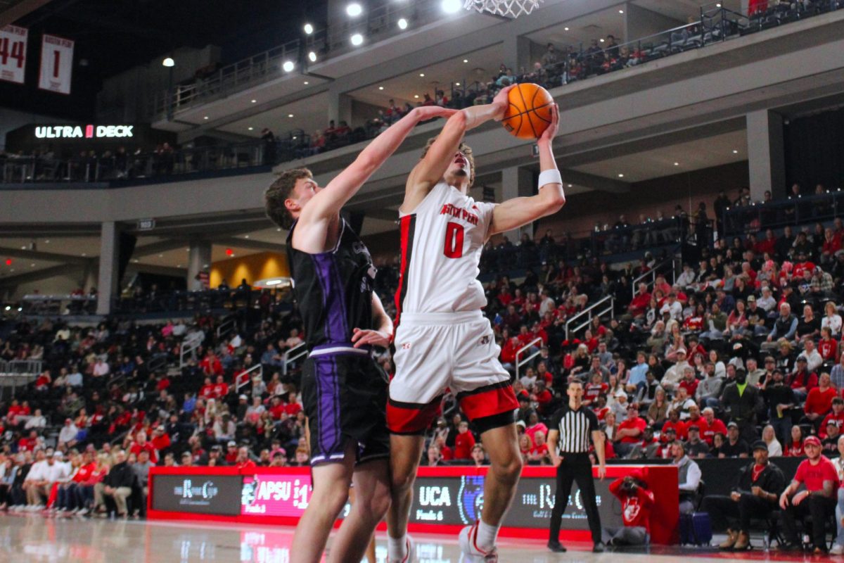 Tate McCubbin fights through a Central Arkansas defender to attack the basket in Austin Peay's 93-88 loss to Central Arkansas on Feb. 25, 2026.