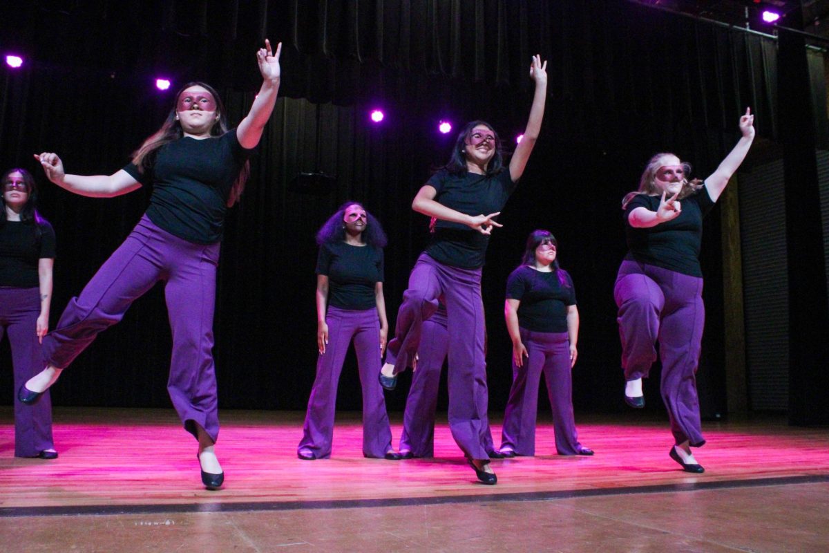 New members Jenifer Garduno, Nora Somers and Ada Lewallen of the Associate Chapter of Sigma Lambda Gamma Sorority, Inc. pose and hold up their sign during their reveal Friday night, April 18, 2026.