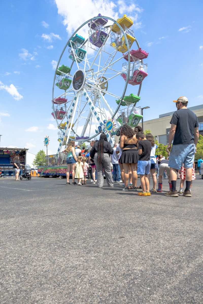 Austin Peay State University students wait in line to board the Ferris wheel during the Springtacular carnival, Saturday, April 11, at the Fortera Stadium parking lot, hosted by the Office of Student Life and Engagement and the Student Government Association.