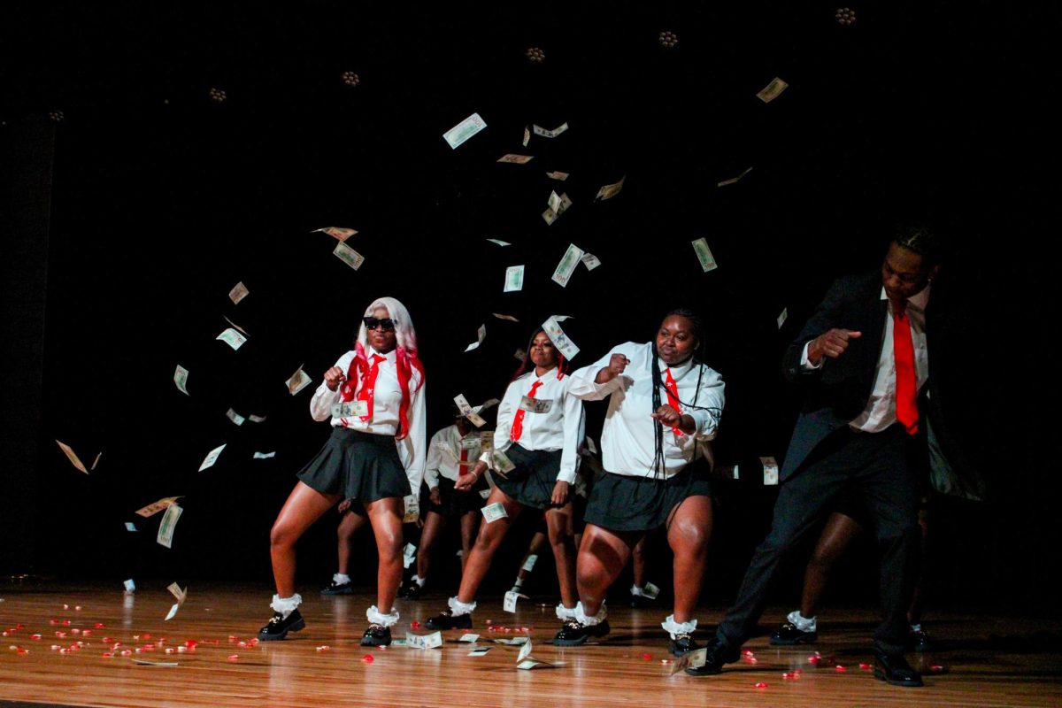 Austin Peay State University students throw money while dancing during Shimmy Like a Nupe (SLAN) on Friday, April 3.