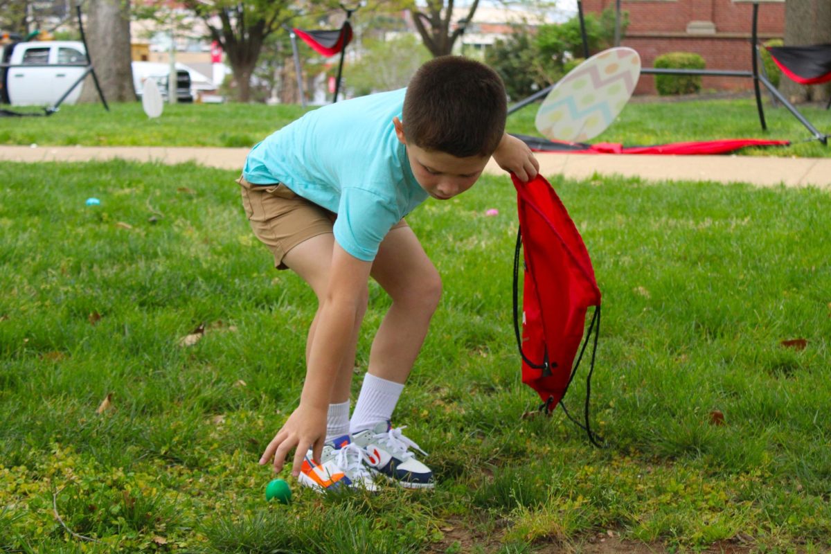 A child picks up an egg during the annual Austin Peay Easter egg hunt on Saturday, April 4, in front of the Browning building.