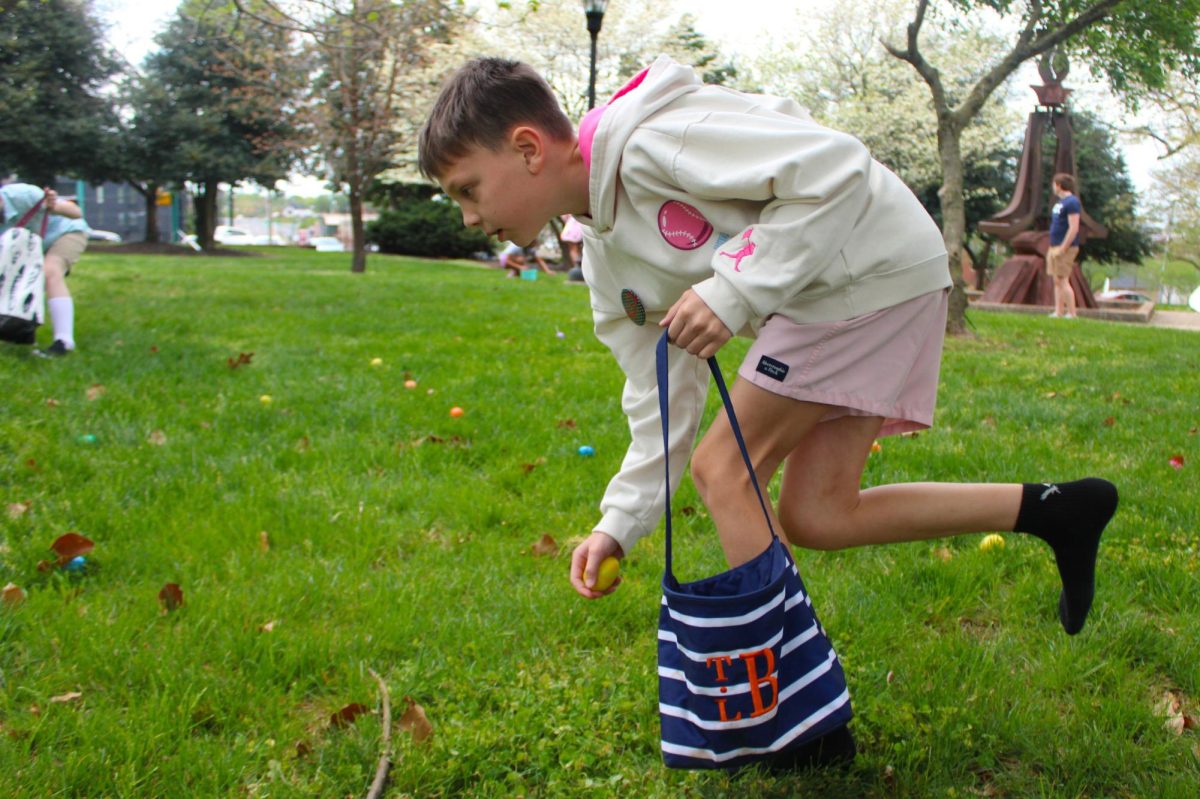 A child runs while gathering eggs during the annual Austin Peay Easter egg hunt on Saturday, April 4, in front of the Browning building.