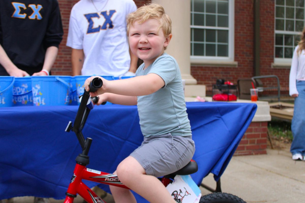 A child wins a bike from a golden egg found during the annual Austin Peay Easter egg hunt on Saturday, April 4, in front of the Browning building.