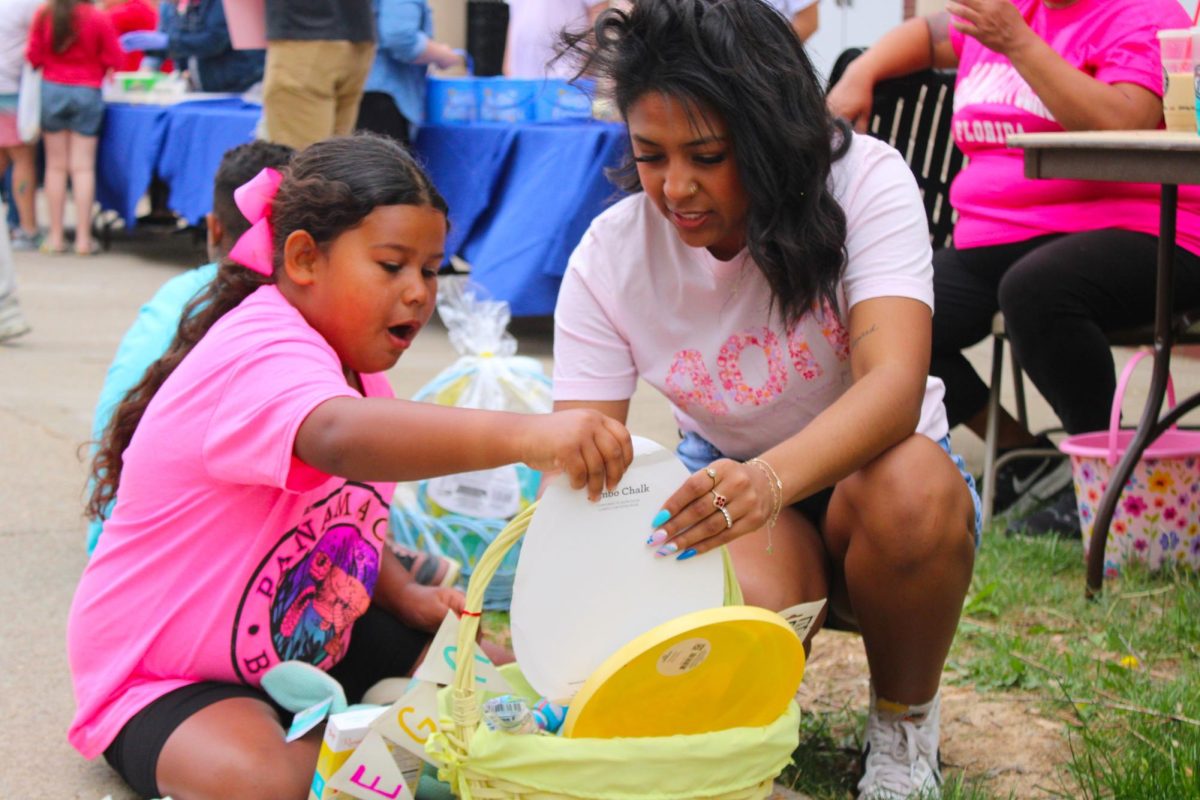 A child looks through her gift basket won from a golden egg found during the annual Austin Peay Easter egg hunt on Saturday, April 4, in front of the Browning building.