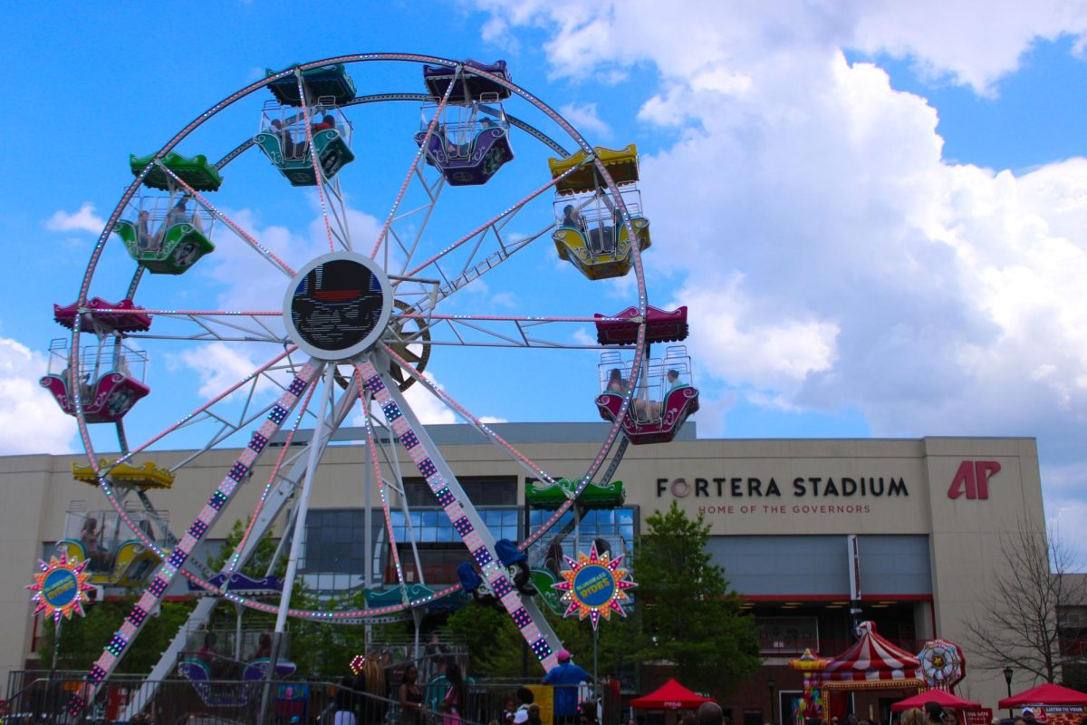 Austin Peay State University students ride the Ferris wheel during the Springtacular carnival hosted by the Office of Student Life and Engagement and the Student Government Association, Saturday, April 11, in the Fortera Stadium parking lot.