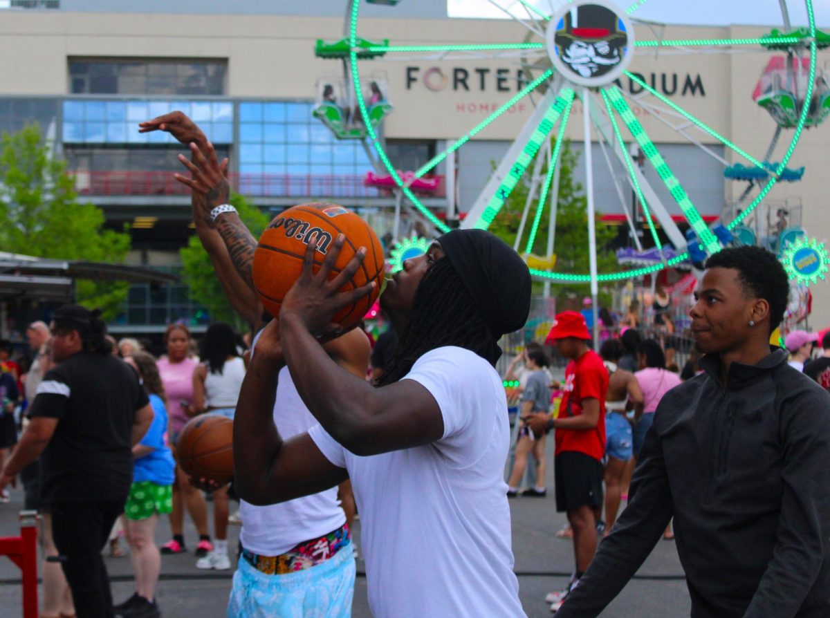 Austin Peay State University student plays a basketball game during the Springtacular carnival, Saturday, April 11, at the Fortera Stadium parking lot, hosted by the Office of Student Life and Engagement and the Student Government Association.
