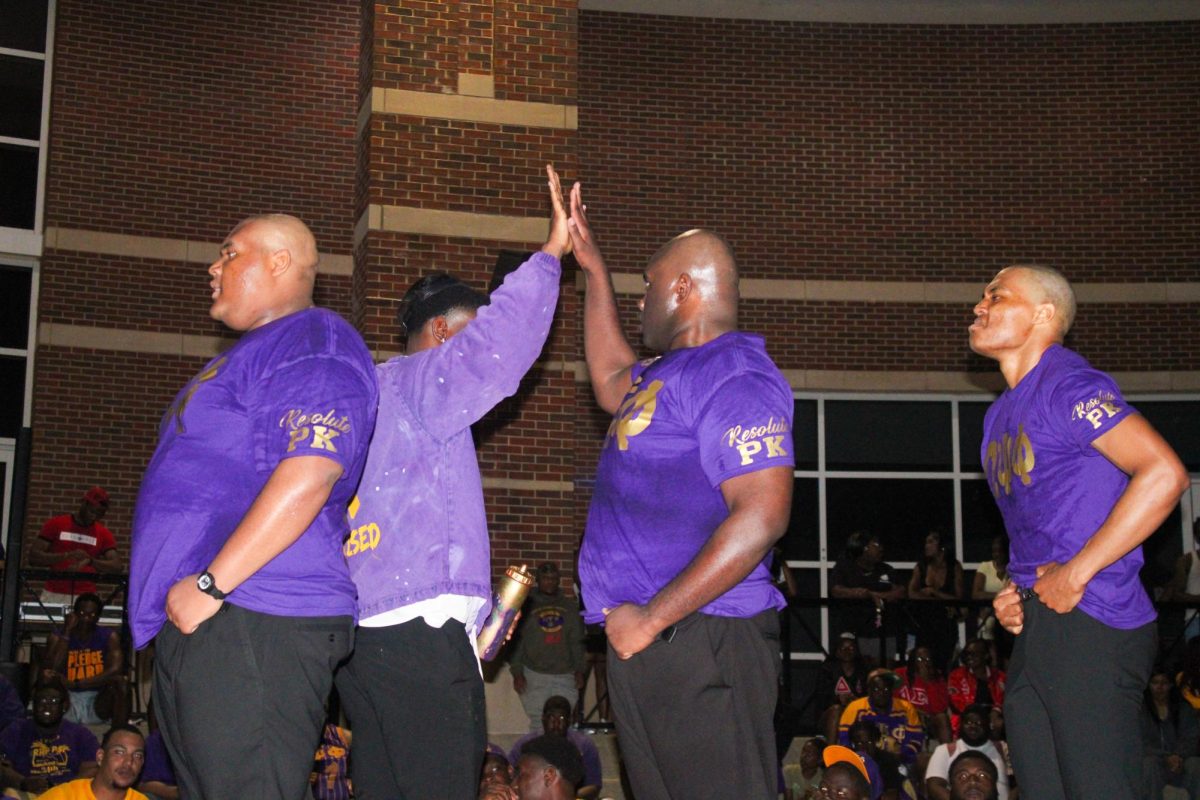 New member Benson Harris of the Rho Kappa Chapter No. 254 of Omega Psi Phi Fraternity, Inc., high-fives his prophyte, Friday night, April 17, 2026.