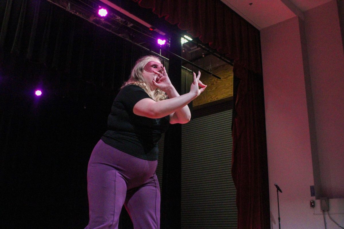 New member Ada Lewallen of the Associate Chapter of Sigma Lambda Gamma Sorority, Inc. crosses her signs during her reveal Friday night, April 18, 2026.