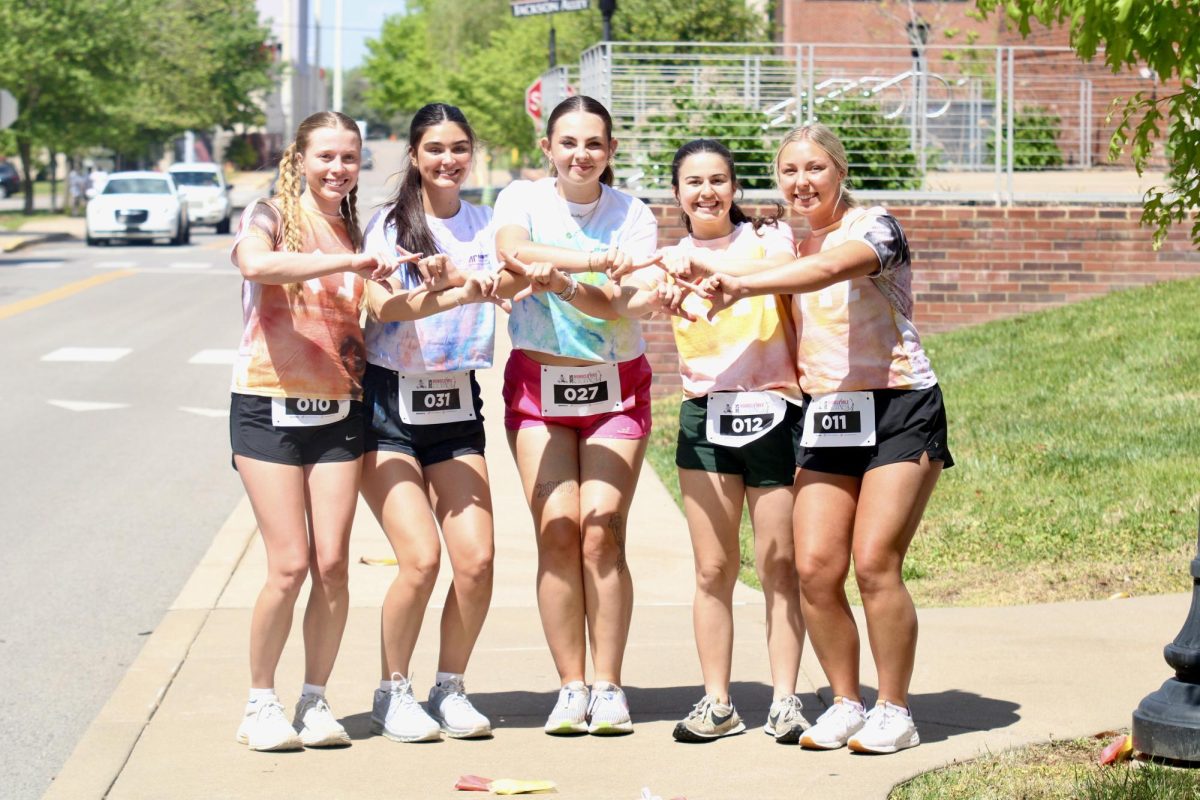 Austin Peay State University Chi Omega members throw up their sign with big smiles before the color run, Sunday afternoon, April 19, 2026.
