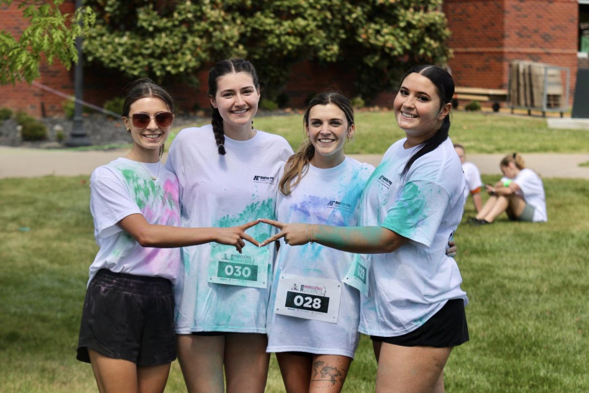 Austin Peay State University Alpha Delta Pi members throw up their sign with big smiles before the color run, Sunday afternoon, April 19, 2026.