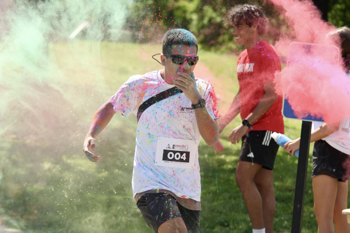 Austin Peay State University student covers his mouth during the color run, Sunday afternoon, April 19, 2026.