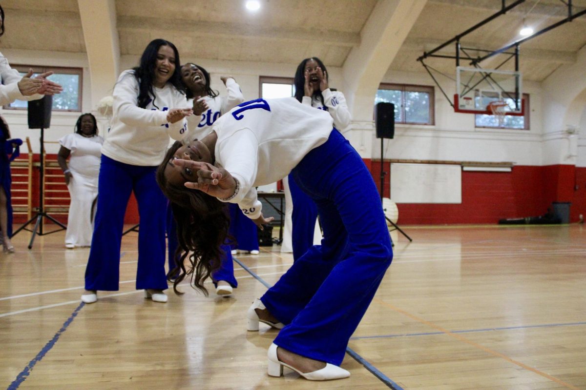 New member Crystel Martinez Rivera of the Gamma Nu chapter of Zeta Phi Beta Sorority, Inc. bends backward and holds up her sign during her reveal on Monday, April 27, 2026.