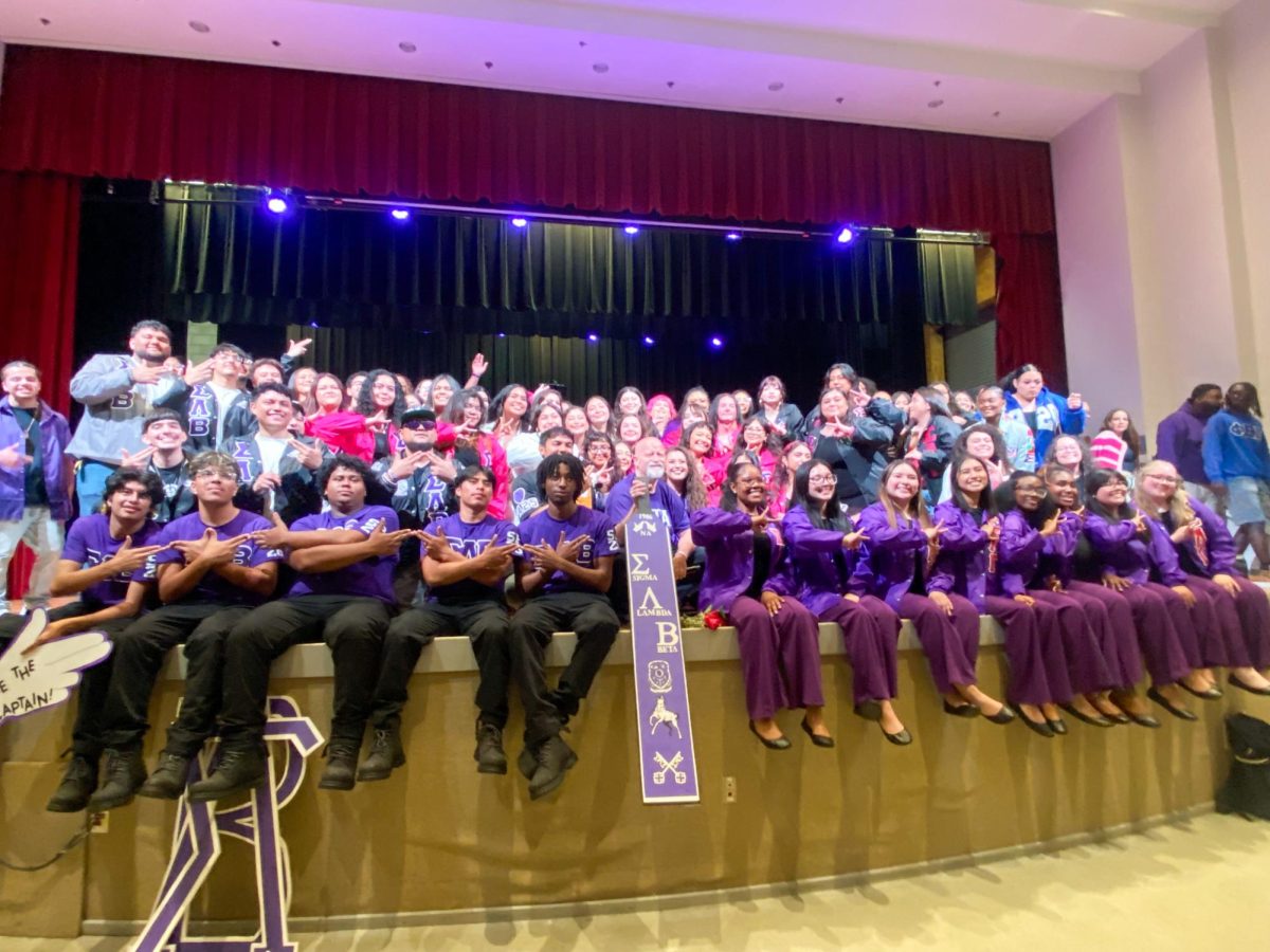 New and returning members of Sigma Lambda Gamma Sorority, Inc. and Sigma Lambda Beta Fraternity, Inc. at Austin Peay State University pose with their signs Saturday, April 18, 2026.